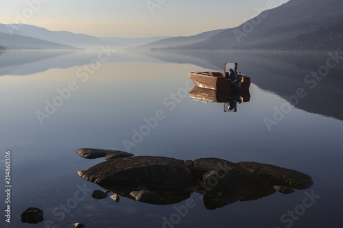 Fishing boat on Loch Arkaig in the early morning, Fort William, Highlands, Scotland, United Kingdom, Europe photo