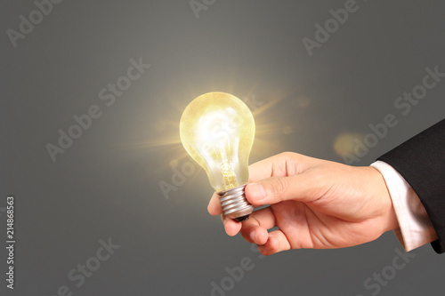 hand holding  light bulb with energy