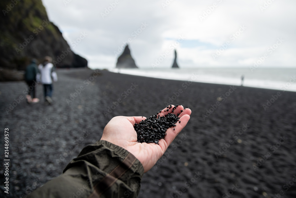 Fototapeta premium Black rocks on hand from black sand beach Reynisfjara Vik ,Iceland.