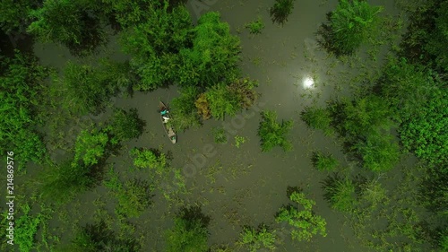 Wallpaper Mural Man on canoe fishing in the Amazon jungle in Brazil, seen overhead from drone, aerial view Torontodigital.ca