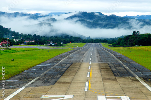 Slika na platnu Airport runway with mountain in countryside