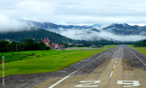 Slika na platnu Airport runway with mountain in countryside