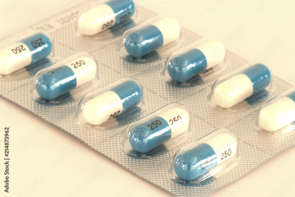 Selective focus of antibiotic capsules pills on white background with copy space. Drug resistance concept. Selective focus of antibiotic capsules pills on white background with copy space. Drug resistance concept.