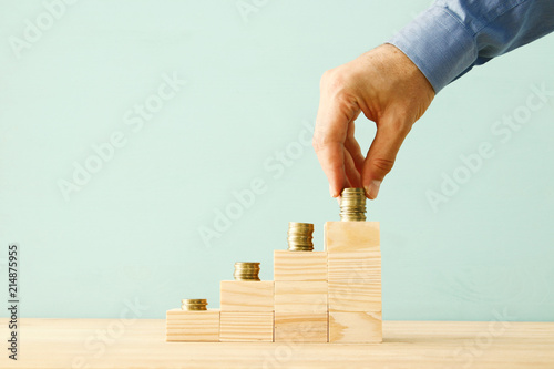 concept image of Saving money or investing. putting stack of coins at the top.