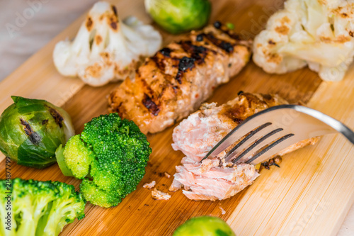Fried salmon on a blackboard with broccoli, colored and Brussels