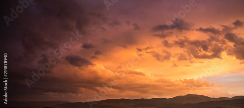 Red cloudy sky at sunset, mountain range, banner, copy space, wallpaper. © viperagp