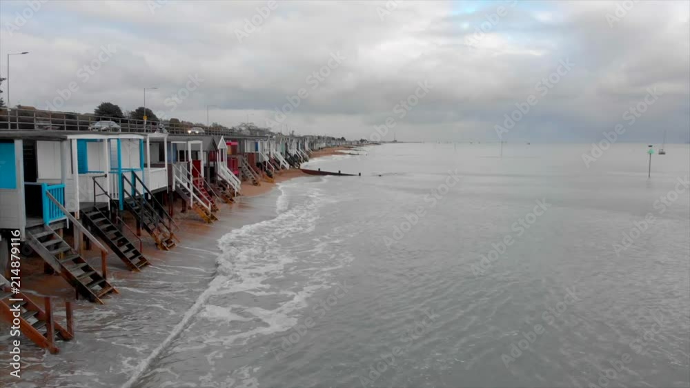 English Beach huts and breaking waves English Beach huts and breaking waves