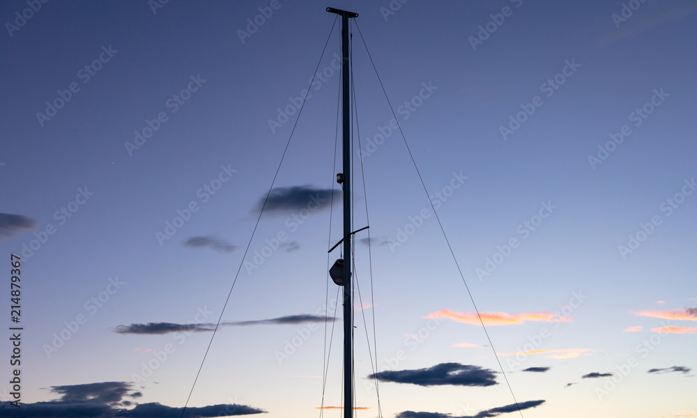 Mast of a sailing boat at sunset, wallpaper and copy space. Mast of a sailing boat at sunset, wallpaper and copy space.