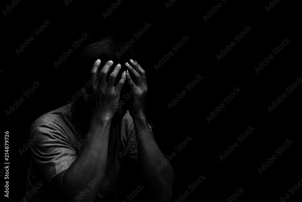 Man sitting alone felling sad worry or fear and hands up on head on black  background Stock Photo | Adobe Stock