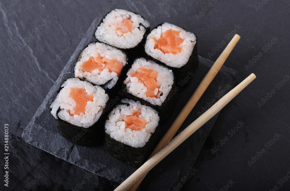 Maki rolls with over grey background. Japanese Sushi. close up. Maki rolls with over grey background. Japanese Sushi. close up.