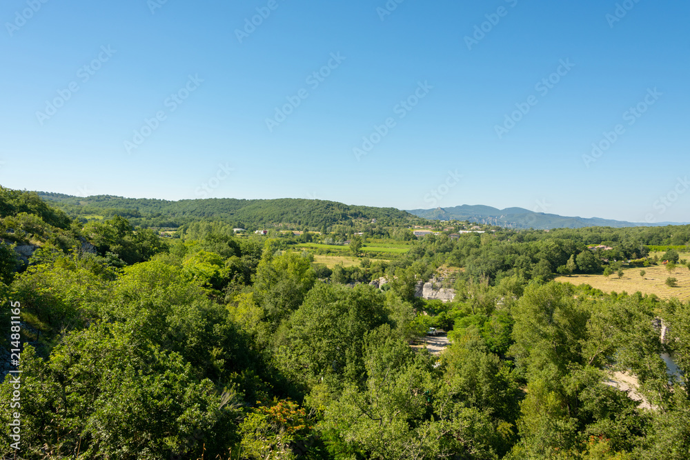 Beautiful panoramic view of the landscape in front of a bright blue sky by the river Ardeche in the south of France