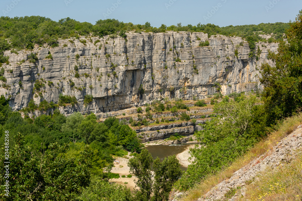 Panorama landscape with the river Ardeche, framed by rock faces and a lot of vegetation at 