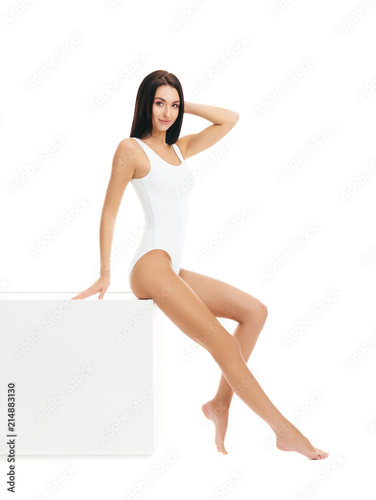 Fit and sporty girl in white swimsuit. Sport, fitness, diet, weight loss and healthcare concept.