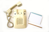 a shot of a tube from an old phone is in a person's hand, on a white background retro home phone with wired handset with