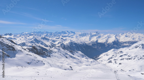 A Breathtaking Panorama of the Snowy Mountains and Skiers © dlogvin