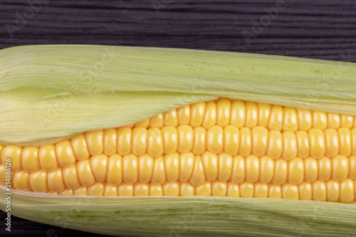 cob  corn on a black wooden background