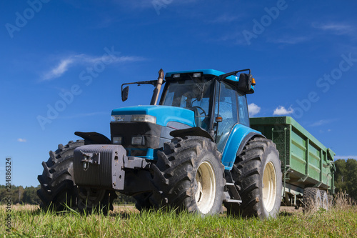 Modern blue tractor in the field