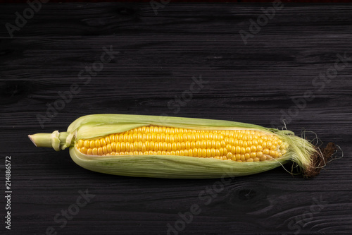 cob  corn on a black wooden background