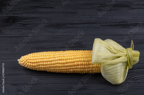 cob  corn on a black wooden background
