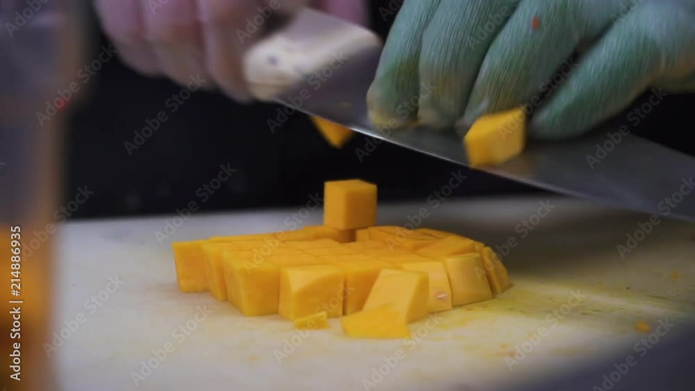 This video contains a person using a knife to cut a melon. They're preparing food and transferring the melon to a bucket. This video contains a person using a knife to cut a melon. They're preparing food and transferring the melon to a bucket.