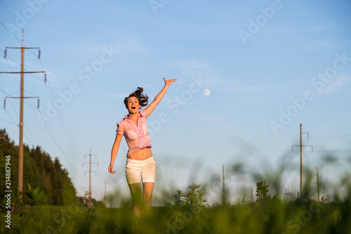 Nice girl have fun in a green field