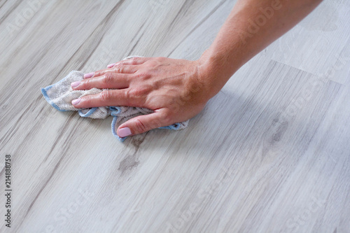 The woman wipes the floor. Floating floor. Housekeeping. Manual wiping of the floor. Woman cleaning floor. Housework.