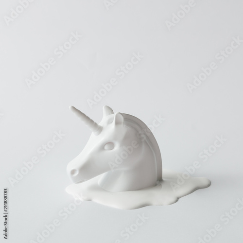 White painted unicorn head on white flat background. Minimal art fantasy concept.