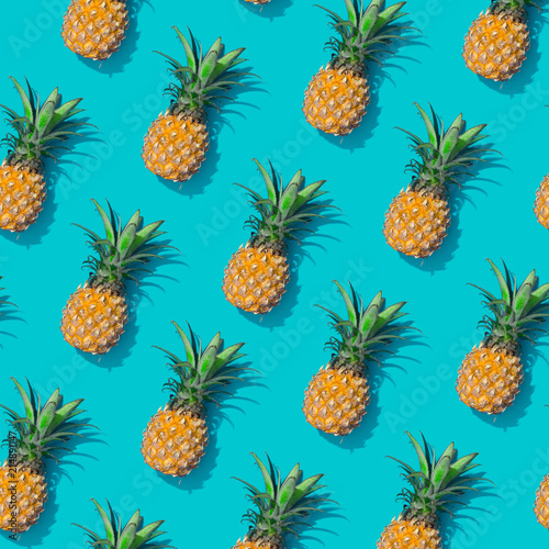 Pineapple creative tropical pattern vivid blue background. Abstract summer art background. Minimal print concept. Flat lay food.