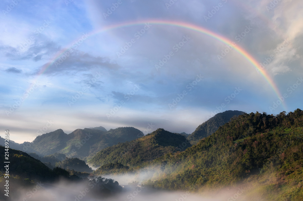Mountain and mist with rainbow.