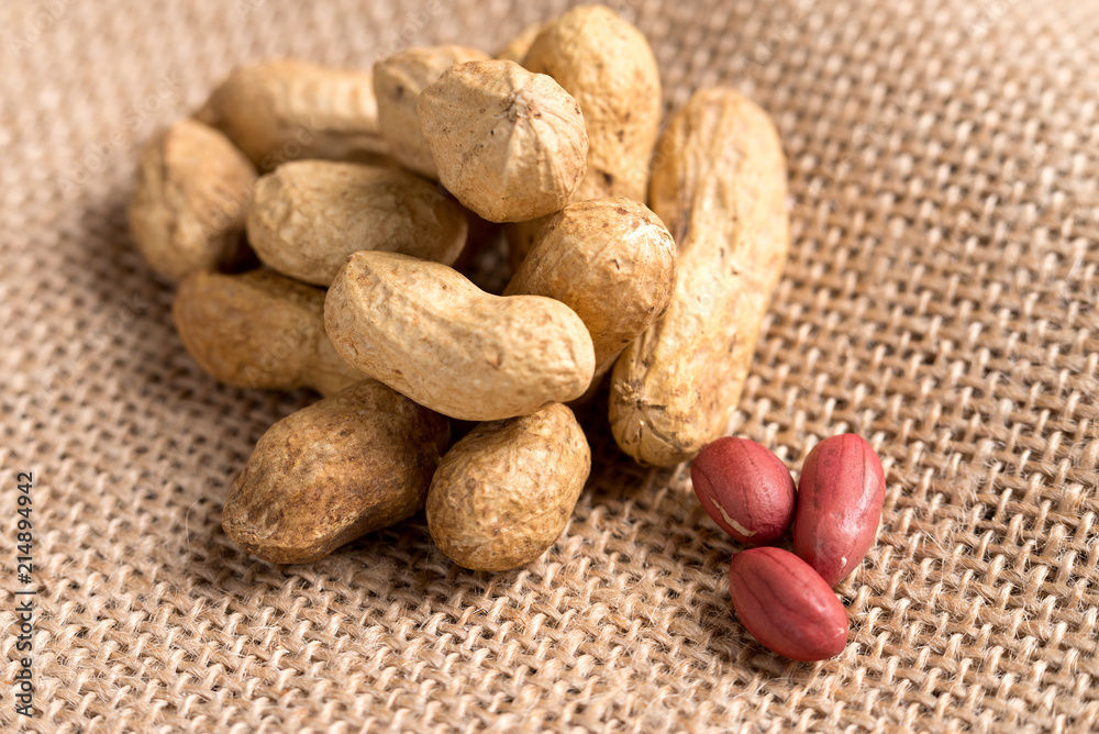 Handful of nuts on burlap, top view. Handful of nuts on burlap, top view.