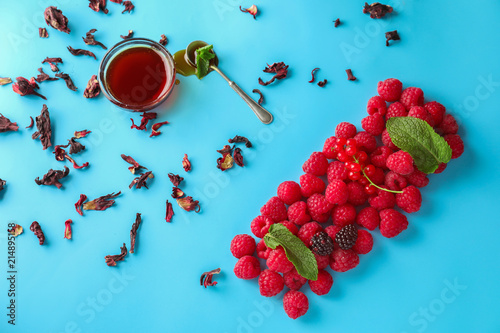 Fotografie Composition with fresh ripe berries and honey on color background