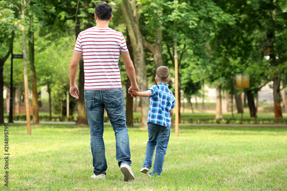 Little boy and his father walking outdoors