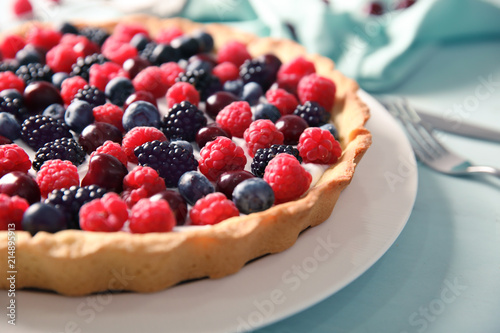 Plate with delicious berry pie on table, closeup