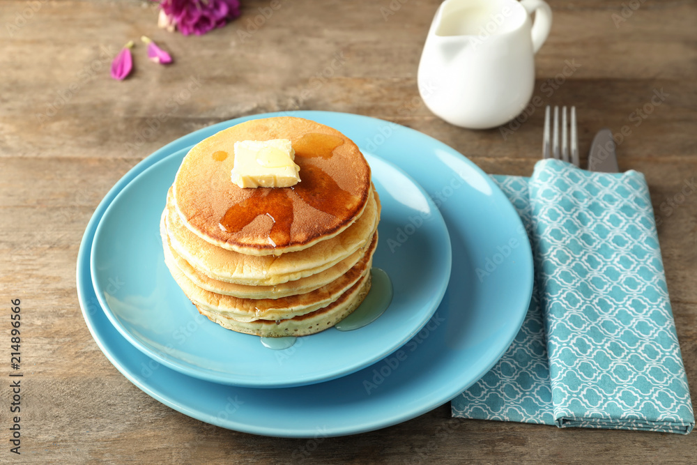 Plate with tasty pancakes on wooden table Plate with tasty pancakes on wooden table