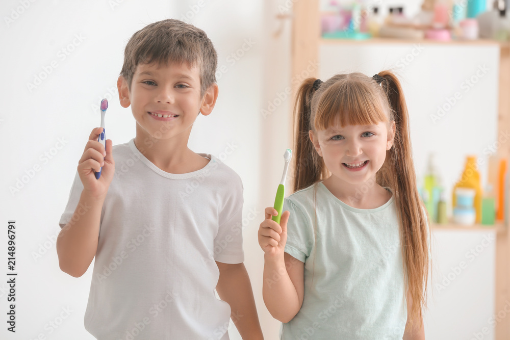 Cute little children with toothbrushes in bathroom Cute little children with toothbrushes in bathroom