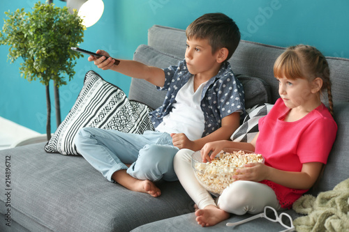 Cute children watching TV o...
