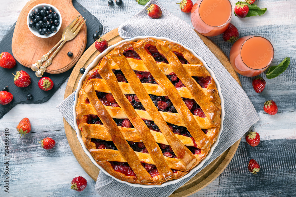 Tasty pie with berries on wooden board Tasty pie with berries on wooden board