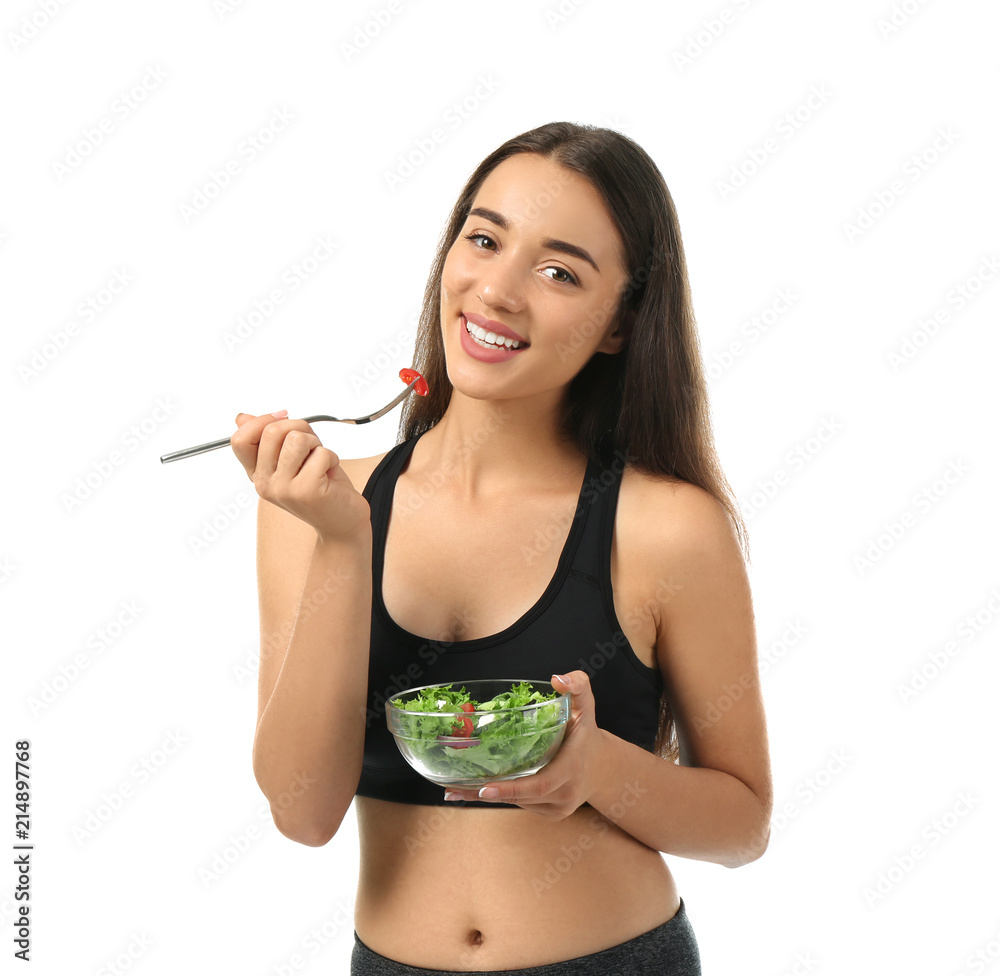 Young sporty woman with fresh vegetable salad on white background Young sporty woman with fresh vegetable salad on white background
