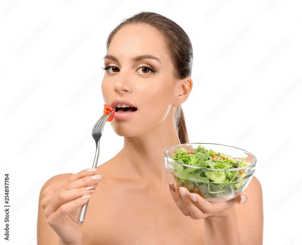 Young woman with fresh vegetable salad on white background Young woman with fresh vegetable salad on white background