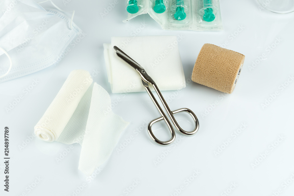 Medical tape with scissors and syringe, white background Medical tape with scissors and syringe, white background