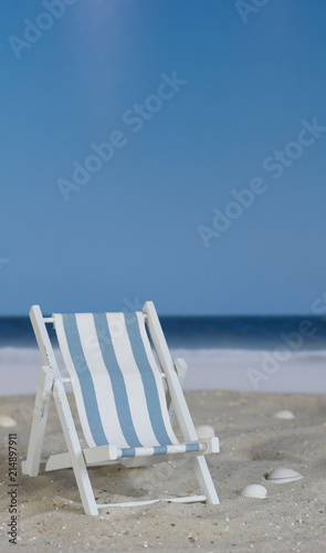 Blue white striped deck chair on the beach