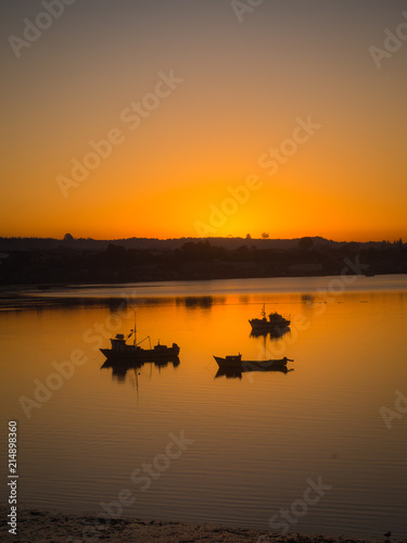 Sunrise at quellón channel with fishing boats © Erlantz