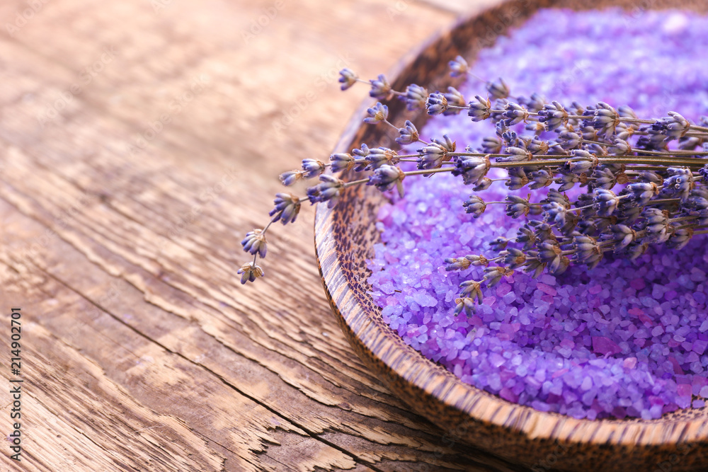 Beautiful lavender and bowl with sea salt on wooden table, closeup Beautiful lavender and bowl with sea salt on wooden table, closeup