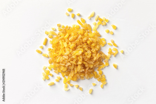 Pile of bulgur raw grain isolated at white background. Macro top view image. photo
