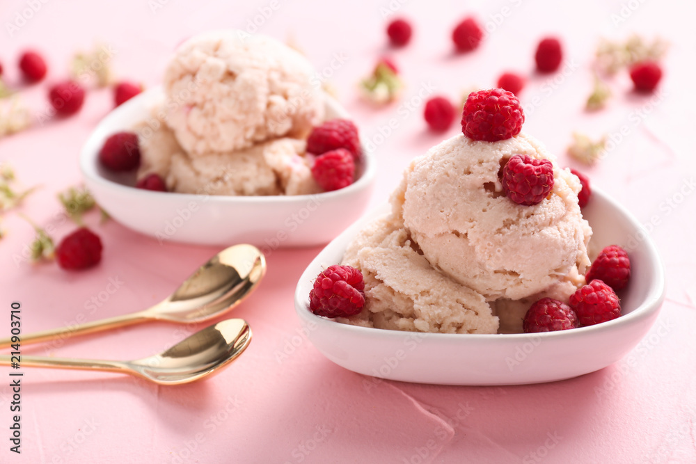 Bowl with tasty ice-cream and raspberries on color background Bowl with tasty ice-cream and raspberries on color background