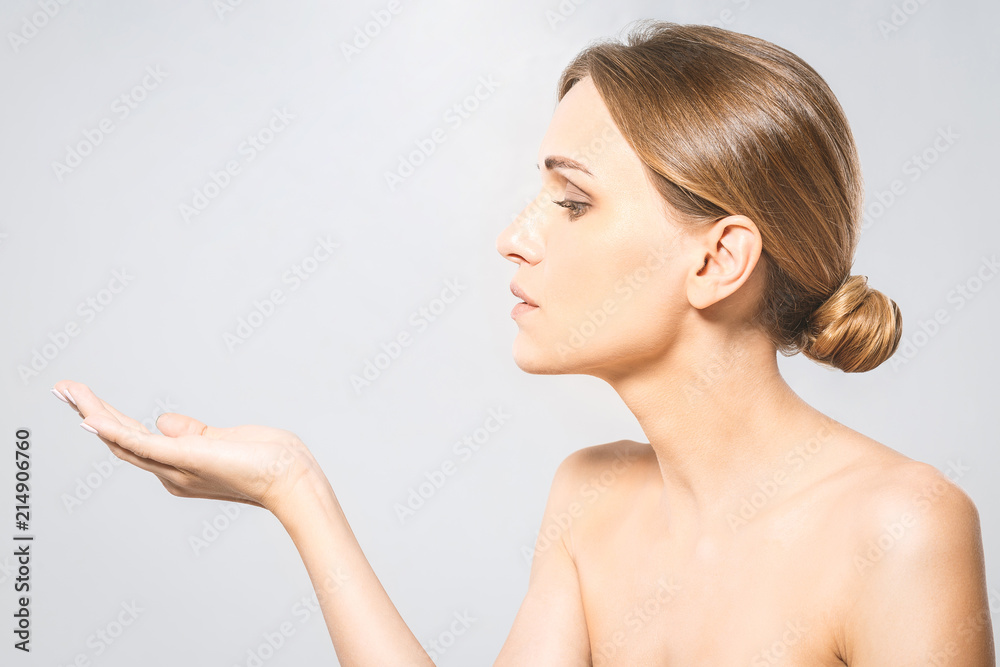 Woman Portrait. Beautiful Spa Girl showing empty copy space on the open hand palm for text. Proposing a product. Skin Care Concept. On white with clipping path Woman Portrait. Beautiful Spa Girl showing empty copy space on the open hand palm for text. Proposing a product. Skin Care Concept. On white with clipping path
