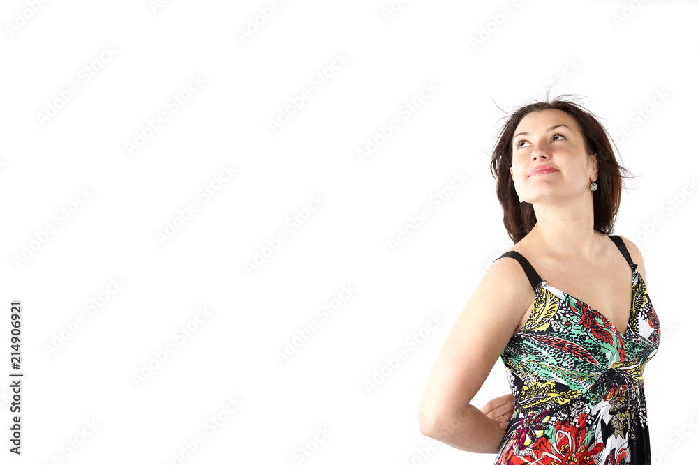 young beautiful woman in sundress with colorful flower pattern looking up young beautiful woman in sundress with colorful flower pattern looking up