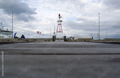 Laesoe / Denmark: View over the bathing jetty to the navigational light on the pier of the ferry port of Vesteroe Havn