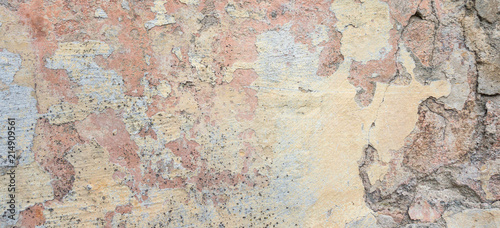 Old Wall With Peel Grey Stucco Texture. Retro Vintage Worn Wall Background. Decayed Cracked Rough Abstract Banner Surface.