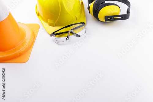 Construction Safety Gear and Traffic Cone on White Background Copy Space